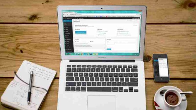 A cozy home office scene with a laptop, notebook, smartphone, and coffee, perfect for productivity., tags: kritische 300.000 - pexel